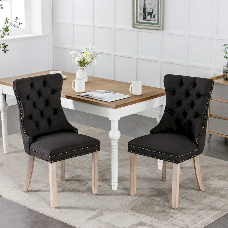 Juego de 2 sillas de comedor tapizadas con ribete de tachuelas y patas de madera maciza