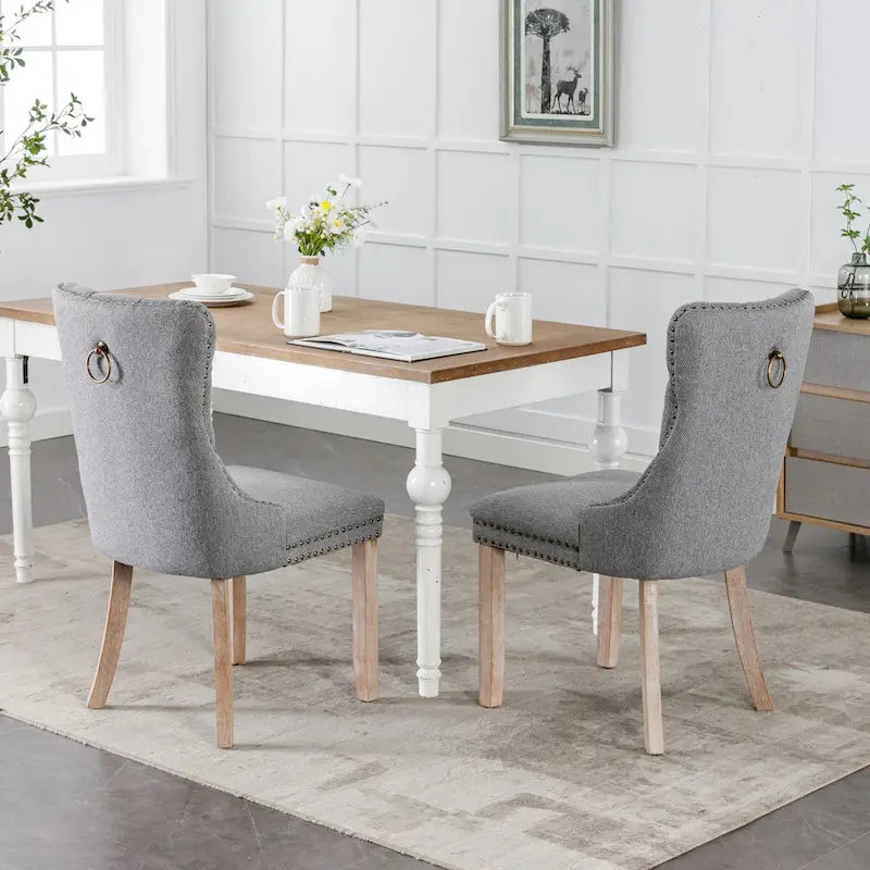 Juego de 2 sillas de comedor tapizadas con ribete de tachuelas y patas de madera maciza